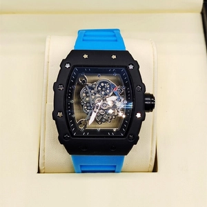 Close-up of skeleton dial mechanical watch with blue rubber strap in a gift box