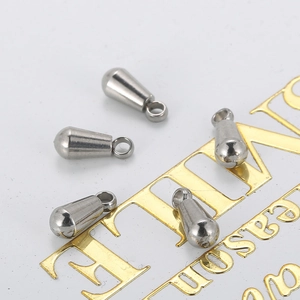 Set of five polished stainless steel teardrop pendants for jewelry making on white background