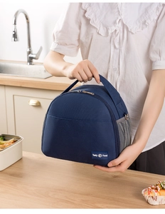 Close-up of navy blue insulated lunch bag with mesh pocket and Tasty Food logo