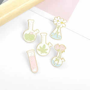 Five-piece pink laboratory flask and test tube enamel pins with daisy and rose motifs