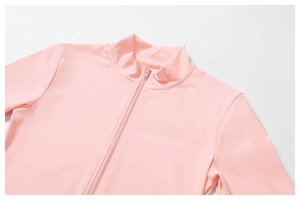 Close-up of pink long-sleeve yoga top with stand collar and seamless zipper detail