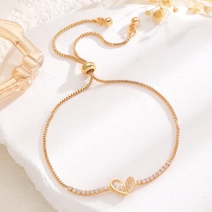 Detailed macro view of the gold butterfly heart pendant with adjustable slider chain closure