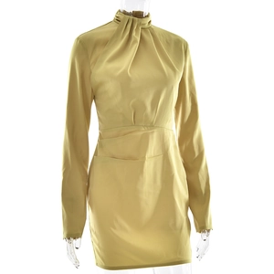 Detail of yellow long sleeve mini dress featuring ruched neck and waist with satin finish