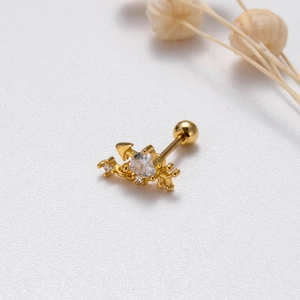 Macro view of gold heart arrow stud earring with zircon inlay and screw ball back