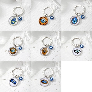 Macro display of assorted Evil Eye and Hamsa hand pendants with blue glass eye patterns