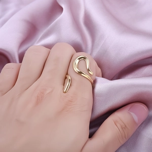 Minimalist 304 stainless steel open ring with gold wavy geometric lines on silk fabric