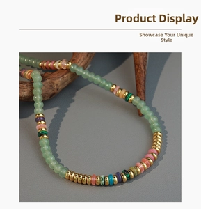 Close-up of handmade natural stone necklace with colorful beads on wooden branch