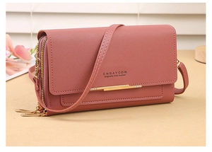 Detail of pink PU leather multi-layer wallet with dual zippers and gold metal trim