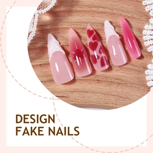 Pink heart design press-on nails with white relief and star accents on wood