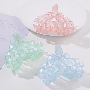 3D flower hair claws in pink, green and blue colors for elegant hair styling