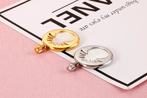 Detail view of gold and silver sunburst pendants with mother of pearl inlay detail