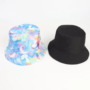 Detail of colorful tie-dye mushroom print and classic black cotton bucket hat