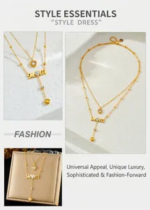 Close-up of gold layered MOM heart necklace with dainty tassel and crystal details