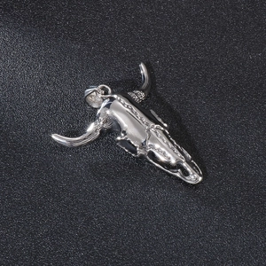 Macro detail of silver ox skull pendant made of polished stainless steel with high luster