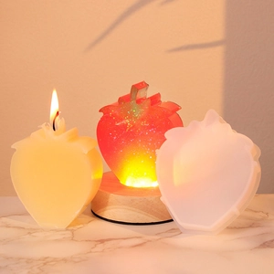 DIY strawberry silicone mold set with finished red glitter resin and yellow candle