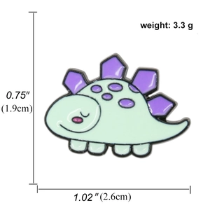 Detail view of cute cartoon dinosaur enamel pin showing dimensions 2.6cm by 1.9cm