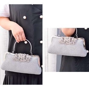 Detail of silver rhinestone evening bag with flower crystal buckle and metal ring handle