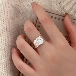 Close-up of S925 sterling silver ring with textured foil finish on a female hand