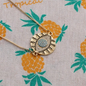 Gold evil eye pendant necklace with turquoise stones and box chain detail