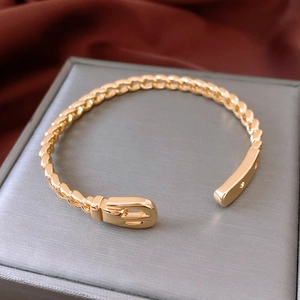 Macro shot of 18K gold plated hollow chain bracelet with a buckle detail on velvet