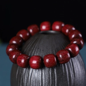 Macro detail of polished dark red violet wood beads showing natural fine textures