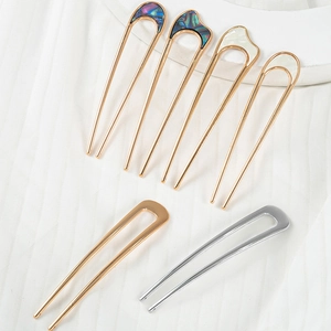 U-shaped metal hair pins with shell inlays and minimalist gold and silver finishes