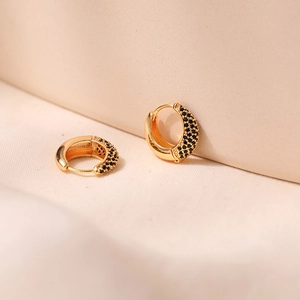 Macro shot of 18K gold plated hoop earrings with micro-pave black zirconia inlay detail