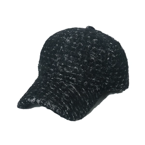 Detailed macro shot of the black tweed fabric texture on a winter baseball cap