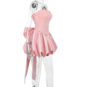 Side view of pink strapless satin mini dress with bubble hem and large back bow detail