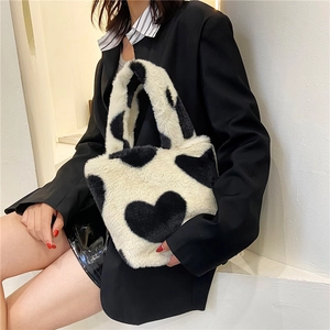Chic plush bucket bag with black and white heart patterns for minimalist winter fashion