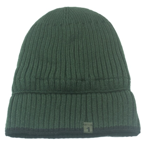 Thick dark green ribbed knit beanie with warm fleece lining and a minimalist label