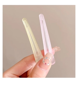 Close-up of matte translucent yellow and pink hair clips with anti-slip texture
