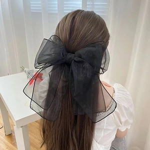 Large black organza ribbon hair clip for women, shown on long hair for a sweet style