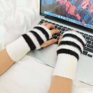 Close-up of black and white striped fingerless faux fur gloves for laptop typing