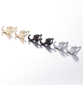 Detailed view of scorpion stud earrings in gold, silver, and black metallic finishes