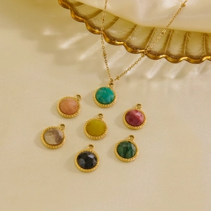 14K gold plated necklace set with seven colorful gemstone pendants on white silk