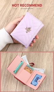 Detail view of purple PU leather bifold wallet featuring bee buckle and multi-card slots