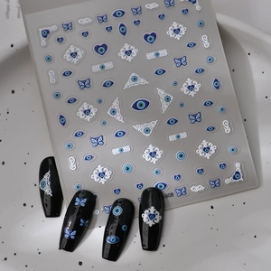 Detailed 5D relief nail stickers featuring blue evil eye, butterfly, and baroque patterns