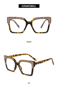 Front and 45-degree views of tortoise shell eyeglass frames with purple glitter accents