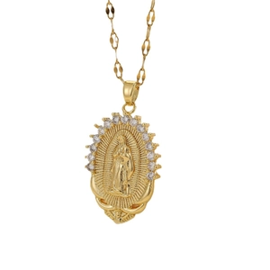 Golden Virgin Mary oval pendant necklace with white zircon stones on a white background