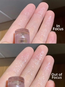 Macro shot of light purple liquid glitter eyeshadow in focused and blurred lighting