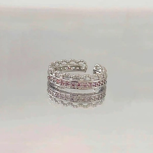 Detail of silver crown ring with double layer design and pink cubic zirconia inlay