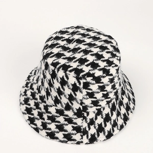 Classic black and white houndstooth bucket hat in thick plush fabric for winter