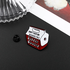 Detail of red and white cooler milk box enamel pin with a black rubber clutch backing