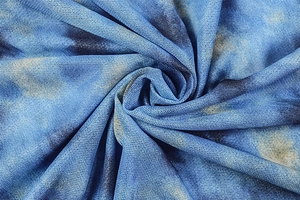 Macro detail of breathable blue tie-dye mesh fabric with fine mesh texture and artistic pattern