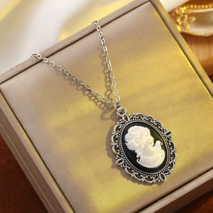 Vintage silver cameo necklace with black and white portrait pendant on jewelry box