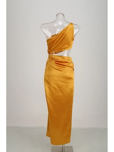 Detail of ginger yellow satin evening dress featuring one-shoulder cut and waist cutout