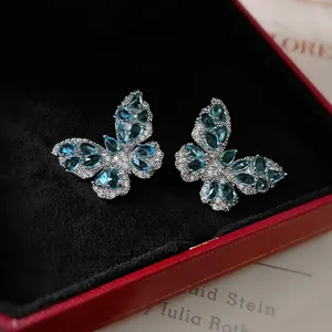 Silver butterfly earrings with blue gemstones and gift box for a luxury fashion look