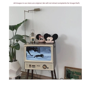 Retro TV shaped decorative cabinet featuring vintage Mickey and Minnie dolls on top