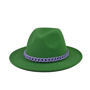 Detail of green felt fedora hat featuring a chunky purple chain link decoration